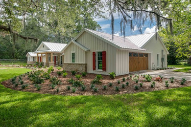 Large cottage white one-story concrete fiberboard exterior home photo in Other with a metal roof