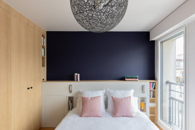 Medium sized contemporary master bedroom in Paris.