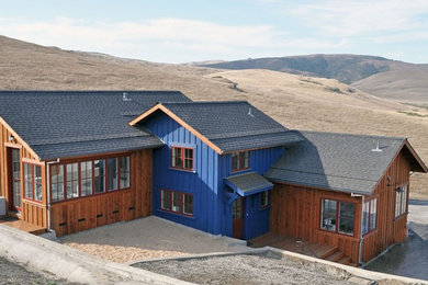 Example of a large urban multicolored two-story wood house exterior design in San Francisco with a shed roof and a shingle roof