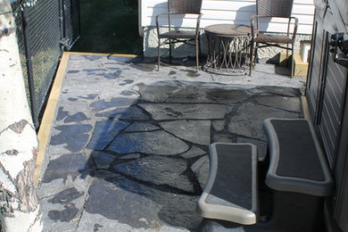 Design ideas for a small partial sun backyard stone garden path in Calgary for summer.