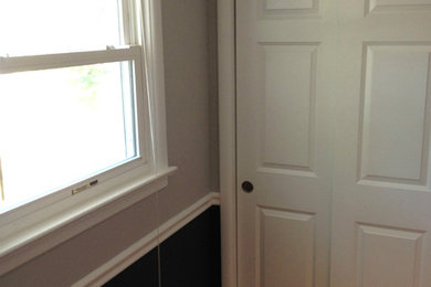 Small elegant guest medium tone wood floor bedroom photo in Newark with gray walls and no fireplace