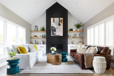 Living room - large country formal and open concept light wood floor and vaulted ceiling living room idea in San Francisco with black walls, a plaster fireplace and no tv