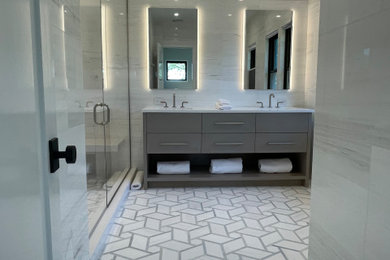 Primary Bathroom with Natural Stone Walls & Mosaic Floor