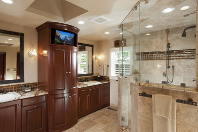 Design ideas for a large traditional master bathroom in San Francisco with a drop-in sink, dark wood cabinets, marble benchtops, a double shower, beige tile, stone tile, beige walls, travertine floors, beige floor, a hinged shower door, a one-piece toilet, multi-coloured benchtops, raised-panel cabinets, a niche, a double vanity and a built-in vanity.
