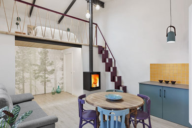 Family room - mid-sized scandinavian loft-style porcelain tile and beige floor family room idea in Alicante-Costa Blanca with white walls, a metal fireplace and no tv