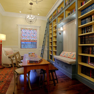 Family room - mid-sized traditional enclosed dark wood floor family room idea in Houston with yellow walls, no fireplace and no tv