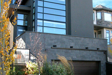 Example of a minimalist black stone flat roof design in Calgary