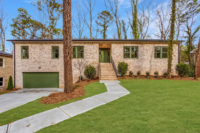 Mid-sized 1960s one-story brick and board and batten house exterior photo in Atlanta with a hip roof, a shingle roof and a black roof