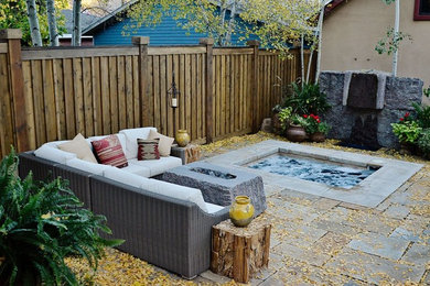 This is an example of a mid-sized transitional backyard patio in Albuquerque with a fire feature, concrete pavers and no cover.