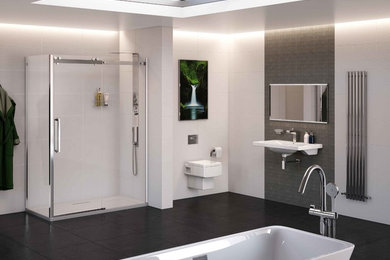 Large modern bathroom in Manchester with a wall-mount sink, a freestanding tub, an open shower, a wall-mount toilet, gray tile, porcelain tile, white walls and porcelain floors.