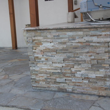 Patio in flagstone, pergola, barbecue, fire pit and deck