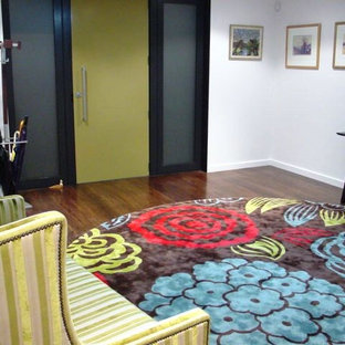 Idéer för en liten eklektisk foajé, med vita väggar, mörkt trägolv, en enkeldörr, en gul dörr och brunt golv