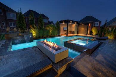 Modern pool in Toronto with a hot tub.