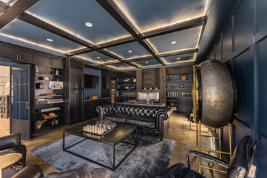 Example of a large trendy home office library design in DC Metro with blue walls