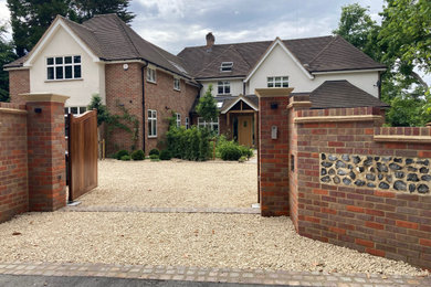 This is an example of a large contemporary entrance in Buckinghamshire with brick walls and a feature wall.