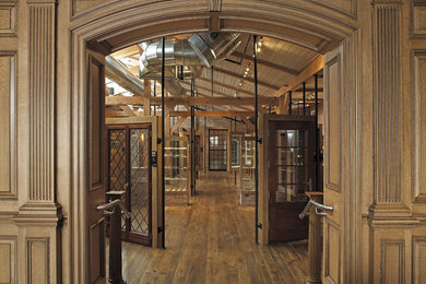 Large elegant medium tone wood floor hallway photo in New York with brown walls