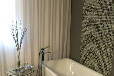 Bathroom - mid-sized contemporary master multicolored tile and glass tile porcelain tile bathroom idea in Toronto with an integrated sink, flat-panel cabinets, gray cabinets, a one-piece toilet and gray walls