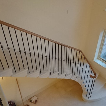 Classic cantilevered Limestone Staircase with simple wrought iron balustrade