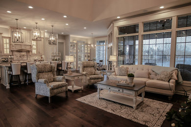 Inspiration for a mid-sized victorian open concept dark wood floor and brown floor living room remodel in Omaha with gray walls, a standard fireplace, a stone fireplace and a wall-mounted tv