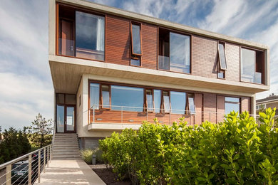 Beach style two-storey house exterior in New York with wood siding.