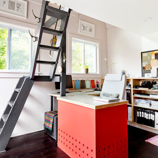 Design ideas for a small modern study in New York with pink walls, dark hardwood flooring and a built-in desk.