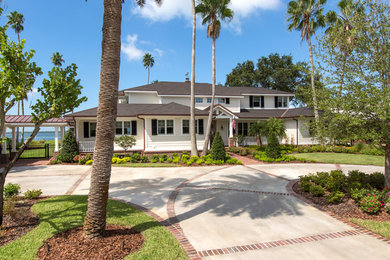 Example of a large transitional white two-story wood gable roof design in Tampa