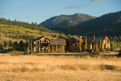 Rustic brown two-story wood exterior home idea in Other