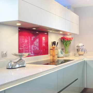 Contemporary white kitchen with red splash back