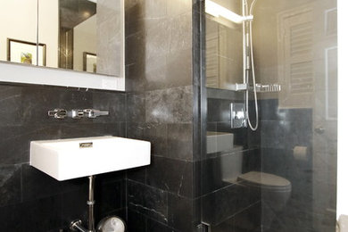 Inspiration for a small modern bathroom in Other with black tile, stone tile and marble floors.
