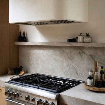 Venetian Plaster Range Hood and Stone Backsplash | Organic Modern Kitchen