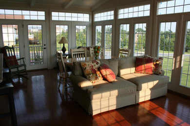 Inspiration for a mid-sized timeless medium tone wood floor sunroom remodel in Other with a standard ceiling
