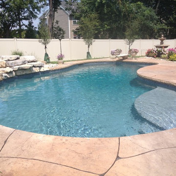 Forks Township custom pool with sunshelf & stone waterfall