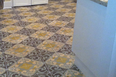 Inspiration for a mid-sized timeless cement tile floor and multicolored floor enclosed kitchen remodel in Miami with white cabinets, granite countertops, stainless steel appliances, recessed-panel cabinets, gray backsplash, ceramic backsplash and a peninsula