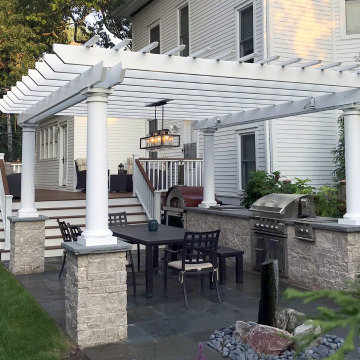 Backyard deck and outdoor kitchen with pergola
