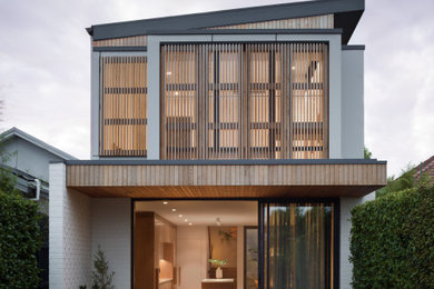 Contemporary two-storey white house exterior in Sydney with a shed roof.