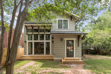 Example of a large gray two-story wood exterior home design in Charlotte with a mixed material roof
