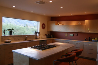 Example of a mid-sized trendy vinyl floor and brown floor open concept kitchen design in Phoenix with an undermount sink, flat-panel cabinets, light wood cabinets, granite countertops, red backsplash, stainless steel appliances and an island