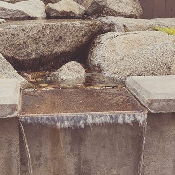Concrete water feature with granite boulders