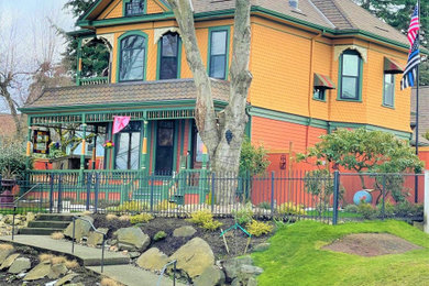 Example of a large ornate two-story exterior home design in Seattle with a shingle roof and a gray roof