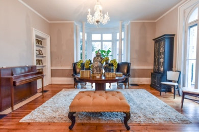 Mid-sized elegant medium tone wood floor hallway photo in Other with gray walls