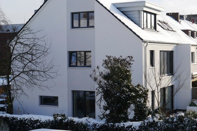Großes, Dreistöckiges Modernes Einfamilienhaus mit weißer Fassadenfarbe, Putzfassade und Satteldach in Hannover