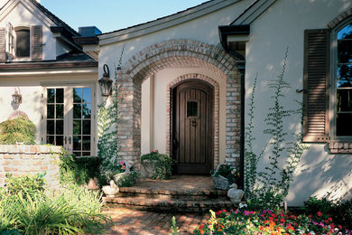 Small tuscan entryway photo in San Francisco with beige walls and a dark wood front door