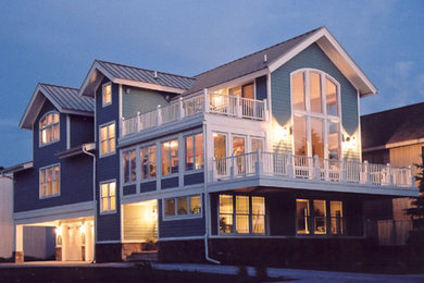 Large transitional blue three-story house exterior photo in Other