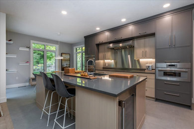 Inspiration for a large modern beige floor kitchen remodel in Toronto with gray cabinets, quartzite countertops, stainless steel appliances and gray countertops
