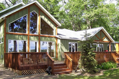 Inspiration for a mid-sized scandinavian green one-story vinyl exterior home remodel in Minneapolis with a hip roof