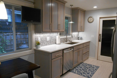 Mid-sized transitional galley light wood floor and brown floor eat-in kitchen photo in Portland with shaker cabinets, white cabinets, quartzite countertops, multicolored backsplash, mosaic tile backsplash, stainless steel appliances, no island, an undermount sink and white countertops
