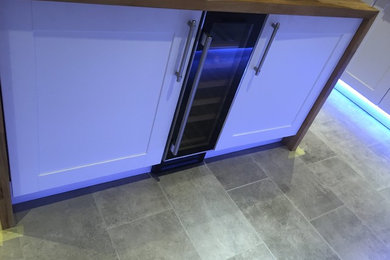 Design ideas for a contemporary kitchen in Other with a belfast sink, wood worktops, ceramic flooring and grey floors.