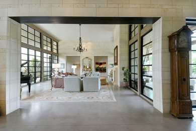 Contemporary open concept living room in Dallas with beige walls, concrete floors, a standard fireplace and grey floor.
