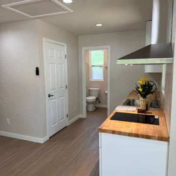 Compact Contemporary Kitchen with Butcher Block Countertops