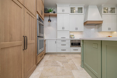Example of a large cottage travertine floor and multicolored floor kitchen pantry design in Los Angeles with a farmhouse sink and white countertops